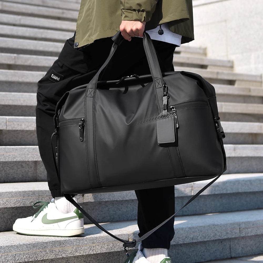 Homme portant le sac de voyage noir à la main dans un escalier