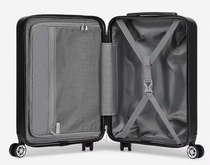 Intérieur de valise rigide noire ouverte : séparateur zippé à poche filet, sangles croisées et roues doubles