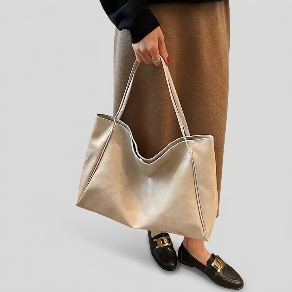 Sac seau aspect cuir souple blanc crème porté à la main